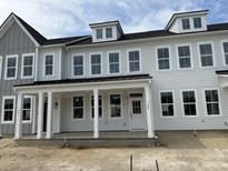 New construction townhouse featuring gray siding, a front porch with white columns, and multiple windows at 760 Blueway Ave, Summerville, SC 29486