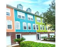 Colorful townhome exterior featuring vibrant paint, brick accents, and well-maintained landscaping at 9019 Parlor Dr, Ladson, SC 29456