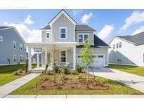 Charming two-story home with a landscaped yard and inviting front porch at 104 Snow St, Summerville, SC 29486