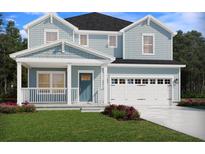 Charming two-story home featuring light blue siding, covered front porch, and a two-car garage at 105 Indigo Cove Blvd, Summerville, SC 29486