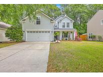 Charming two-story home with light gray siding, attached garage, well-manicured lawn, and a welcoming front porch at 110 Moon Shadow Ln, Summerville, SC 29485