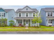 Charming two-story home with a welcoming front porch and manicured lawn at 120 Loon Dr, Summerville, SC 29483