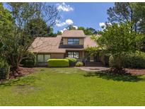 Charming home with lush green lawn, mature trees, and well-maintained landscaping, creating great curb appeal at 1218 Chersonese Round, Mount Pleasant, SC 29464