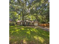 Charming brick home with a green front door and a well-manicured lawn, shaded by a large tree at 141 Larson Dr, Summerville, SC 29485