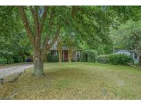 Charming home with a front yard framed by a mature tree and lush greenery at 2177 Gulf Dr, Mount Pleasant, SC 29464