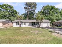 Charming single-story home with well-maintained lawn and two palm trees, ideal for a relaxed coastal lifestyle at 242 Amy Dr, Goose Creek, SC 29445