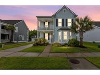 Charming two-story home with a covered front porch, manicured lawn, and lush landscaping at 2881 Rutherford Way, Charleston, SC 29414