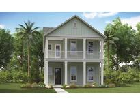 Charming two-story home with a covered balcony, columns, and lush landscaping at 308 Archar St, Summerville, SC 29486