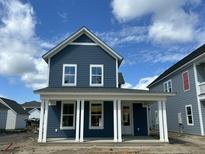 Charming two-story home featuring blue siding, white trim, and a welcoming front porch at 333 Trailmore Ln, Summerville, SC 29486
