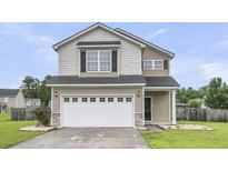 Inviting two-story home with neutral siding, a two-car garage, and well-maintained landscaping at 423 Watershed Dr, Goose Creek, SC 29445