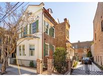 Charming brick and stucco home with lovely green shutters and an inviting gated entrance at 43 Hasell St, Charleston, SC 29401