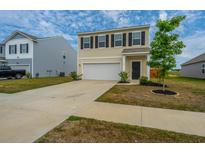 Charming two-story home with a well-maintained front yard and attached one car garage at 430 Pender Woods Dr, Summerville, SC 29486