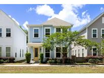 Charming two-story home with light blue siding, manicured landscaping, and a welcoming yellow front door at 4621 Holmes Ave, North Charleston, SC 29405