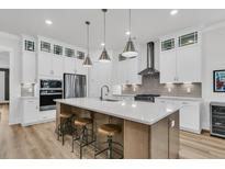 A modern kitchen with stainless steel appliances, a large center island, and pendant lighting at 511 Ocean Mist Way, Summerville, SC 29486