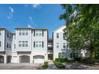 Charming condo building featuring a private garage and inviting entrance on a beautiful sunny day at 60 Fenwick Hall Allee # 432, Johns Island, SC 29455