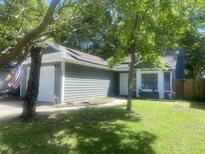Charming single-story home boasts lush landscaping and a welcoming entrance, creating inviting curb appeal at 8254 Timberidge Ct, North Charleston, SC 29420