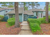 Charming townhome featuring mature landscaping leading to a welcoming front entrance at 1115 Shadow Lake Cir, Mount Pleasant, SC 29464
