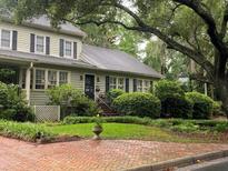 Charming home with a well-manicured lawn, beautiful landscaping, and a brick walkway leading to the entrance at 116 W 5Th South St # D, Summerville, SC 29483