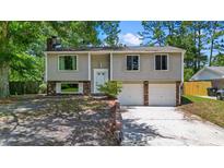 Charming two-story home with a brick and siding exterior, mature trees and attached two-car garage at 117 Canaberry Cir, Summerville, SC 29483