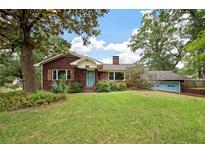 Charming red brick home with a well-manicured lawn and a bright blue front door at 1603 Culpepper Cir, Charleston, SC 29407
