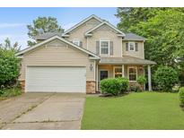 Charming two-story home boasts manicured lawn, a two-car garage, and inviting front porch at 200 Commencement Blvd, Ladson, SC 29456