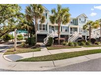 Charming townhomes boast a coastal aesthetic with palm trees and well-maintained landscaping at 2200 Hamlin Sound Cir, Mount Pleasant, SC 29466