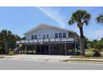 Beautiful elevated beach house with a large wraparound deck and parking underneath at 2401 Palmetto Blvd, Edisto Island, SC 29438