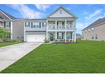 Charming two-story home featuring a double porch, well-manicured lawn, and attached garage at 300 Saxony Loop, Summerville, SC 29486