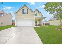 Charming two-story home featuring an attached two car garage and a well-manicured front yard at 3055 Nantuckett Ave, North Charleston, SC 29420