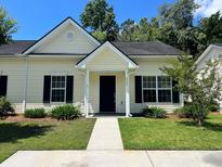 Charming single-story home with well-maintained landscaping, dark shutters, and a inviting front entrance at 311 Dupont Way, Summerville, SC 29485