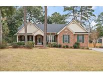 Charming brick home with green shutters and a well-manicured front yard at 315 Clubview Rd, Summerville, SC 29485