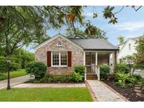 Charming brick home with mature landscaping and a welcoming front porch at 36 Nicholson St, Charleston, SC 29407