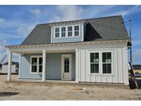 Charming single-story home showcasing a welcoming porch, light blue siding, and white trim under a gray shingled roof at 363 Trailmore Ln, Summerville, SC 29486
