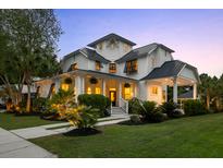 Stunning two-story white home featuring a welcoming front porch and beautifully landscaped front yard at 4009 E Amy Ln, Johns Island, SC 29455