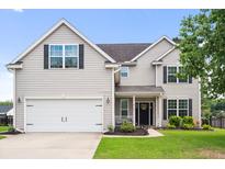 Charming two-story home with a well-manicured lawn, white garage door and black shutters at 428 Cabrill Dr, Charleston, SC 29414