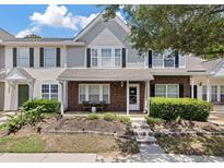 Charming brick and siding townhome featuring a cozy front porch and manicured landscaping at 432 Doane Way, Wando, SC 29492