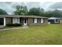 Charming single-story brick home featuring a well-maintained lawn and classic black shutters at 4462 Hardwood St, Ladson, SC 29456