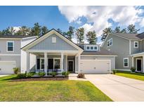 Charming single-Gathering home with a welcoming front porch, manicured lawn, and a two-car garage at 524 Richfield Way, Summerville, SC 29486