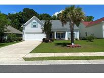 Charming single-Gathering home featuring a well-manicured lawn, and attached two car garage at 7517 Whispering Oak Dr, Hanahan, SC 29410