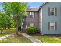 Charming two-story townhouse with gray and brown siding, steps, and a well-maintained lawn at 7921 Cricket Ct # 305 E, North Charleston, SC 29418