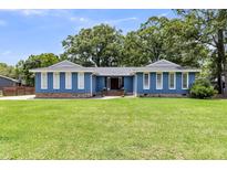 Charming single story home boasting a well-manicured lawn and a striking blue exterior at 809 O'Sullivan Dr, Mount Pleasant, SC 29464