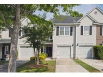 Charming townhouse featuring a one-car garage and tidy landscaping at 1054 Bennington Dr, Charleston, SC 29492