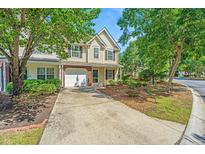 Charming two-story home with a manicured lawn and inviting front entrance, complemented by lush trees at 149 Darcy Ave, Goose Creek, SC 29445