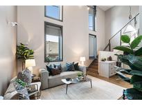 Bright living room featuring high ceilings, modern furnishings, and a cozy atmosphere at 2 Francis St # H, Charleston, SC 29403