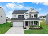 Charming two-story home with brick and white siding, a well-manicured lawn, and a two-car garage at 211 Squire Pope Rd, Summerville, SC 29486