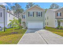 Charming two-story home with a well-manicured lawn and a two-car garage in a friendly neighborhood at 260 Sweet Cherry Ln, Summerville, SC 29486