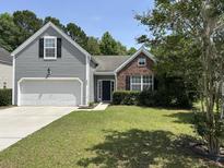 Beautiful two-story home with a well-manicured lawn and mature trees at 4804 Oak Haven Pl, Summerville, SC 29485