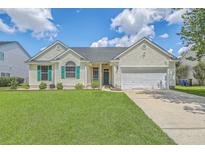 Charming single-story home with a well-manicured lawn, a two-car garage, and decorative green shutters at 6179 Fieldstone Cir, Charleston, SC 29414
