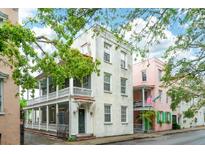 Charming multi-story home featuring a large front porch, offering an inviting and classic appeal at 66 Beaufain St, Charleston, SC 29401