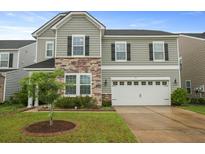 Two-story home featuring stone accents and a two-car garage at 700 Silver Moss Dr, Moncks Corner, SC 29461